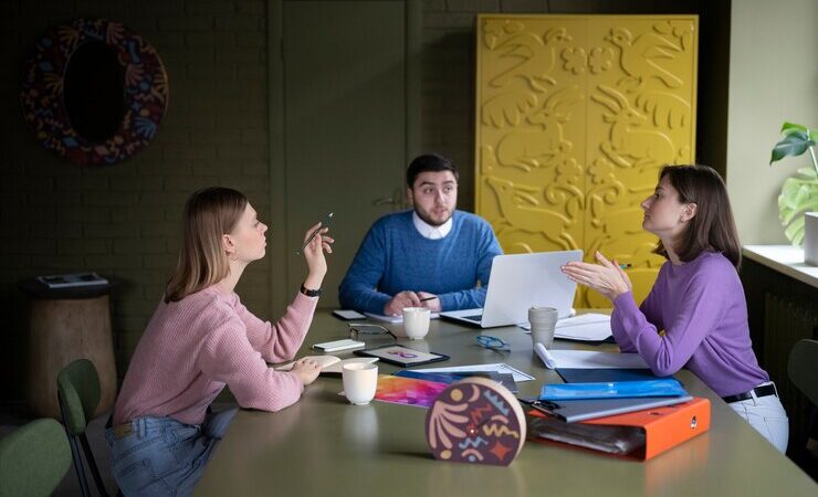 Medium shot people sitting at table discus about Benefits of Taking a Trial Classes