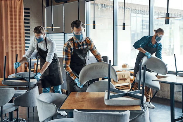 Professionals performing retail cleaning in a store, showcasing polished floors and sanitized shelves.