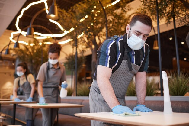 Professionals performing retail cleaning in a store, showcasing polished floors and sanitized shelves.